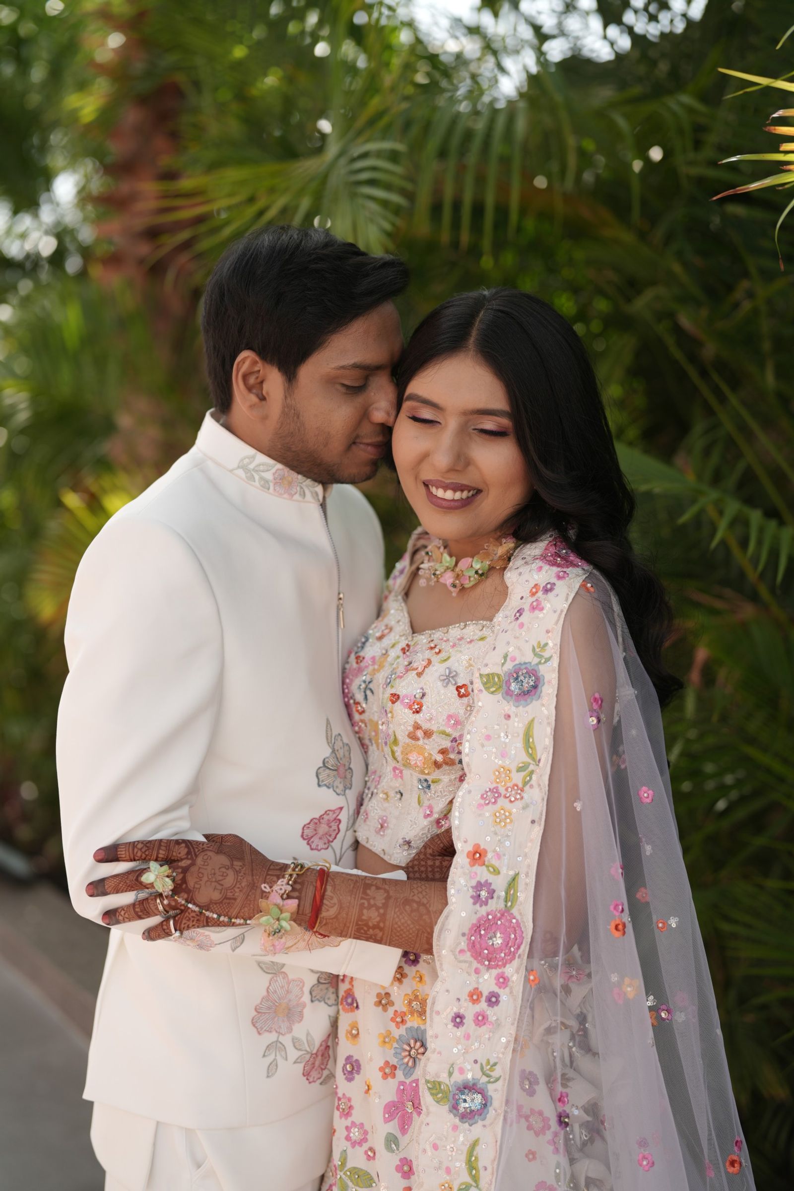 Ravi holding Saloni close in the garden, both smiling