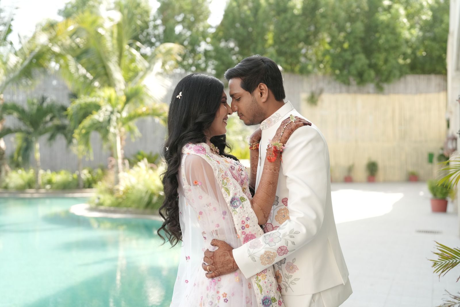 Ravi and Saloni by the pool, foreheads touching