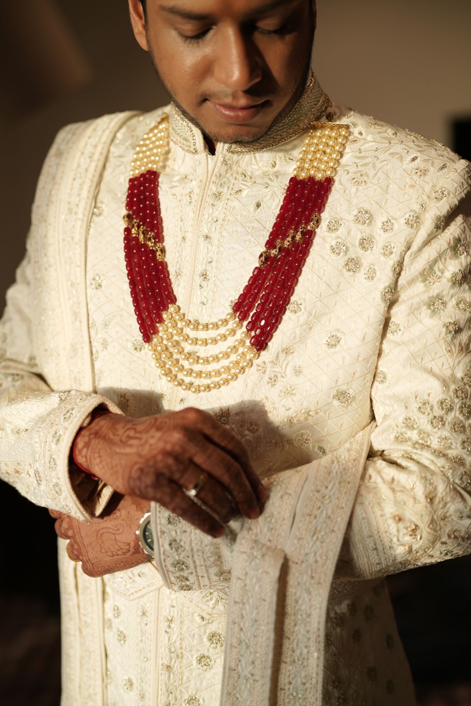 Ravi buttoning his sherwani
