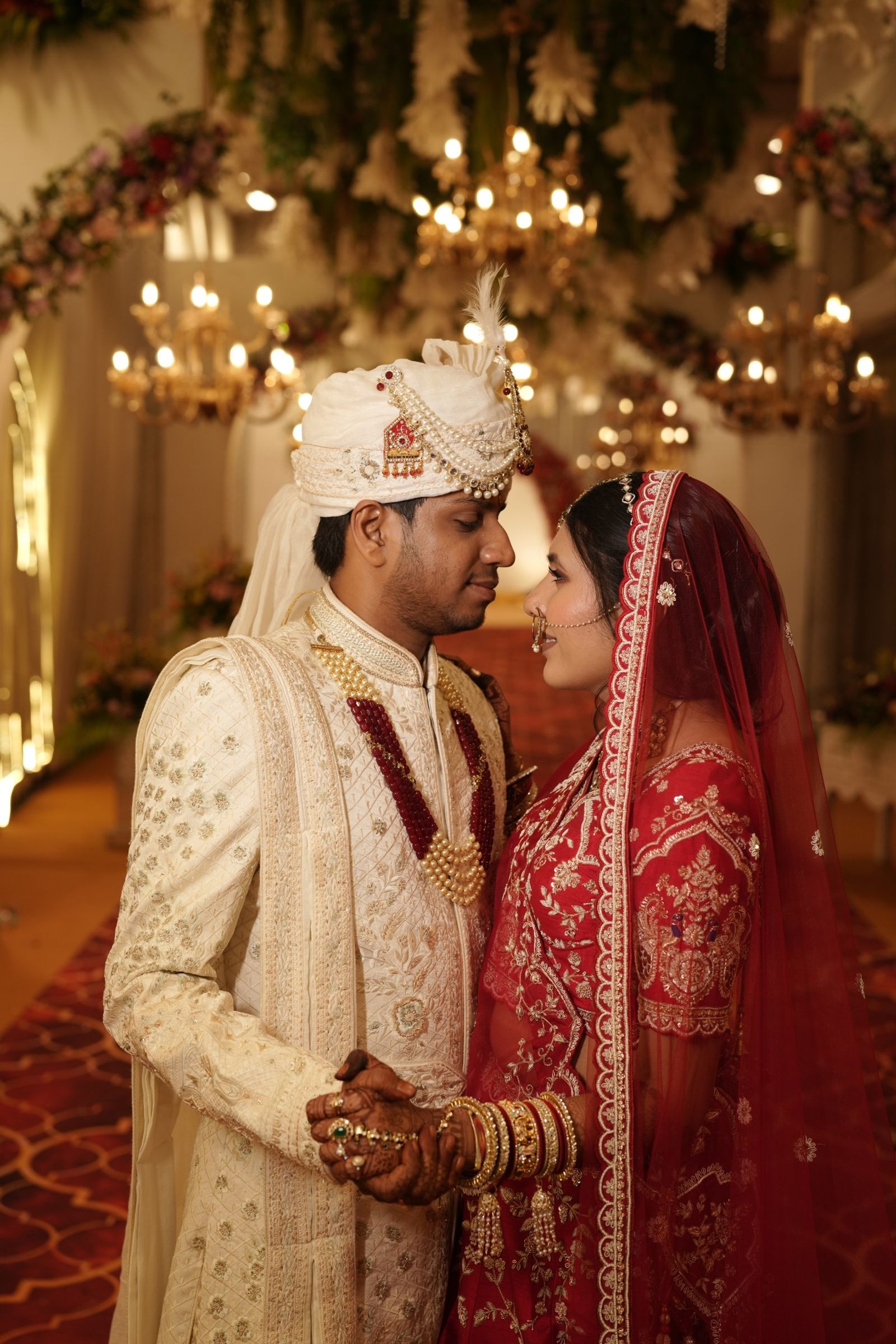 Ravi and Saloni under the chandeliers, foreheads close