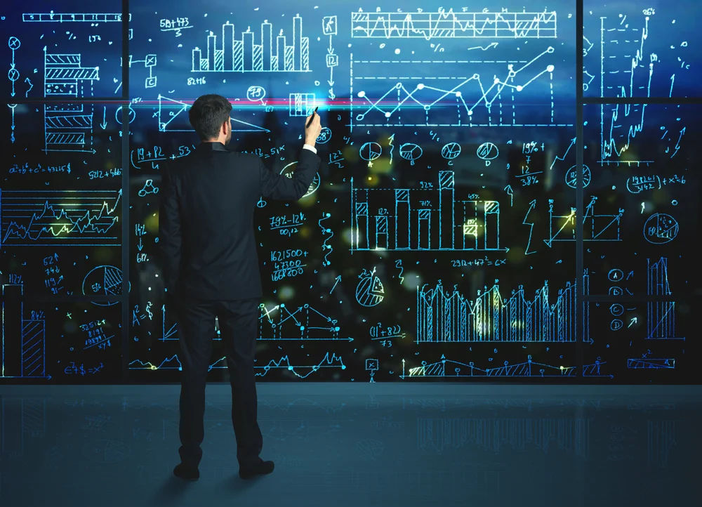 6300-businessman-drawing-business-statistics-on-glass-wall.webp