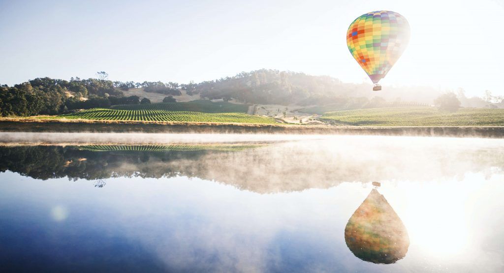 Hot air balloon over Napa Valley vineyard sunrise