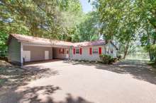 The back of the house features a large carport with storage room and outdoor utility room plus storage building. The carport is 28x19 with storage sheds in the back. 