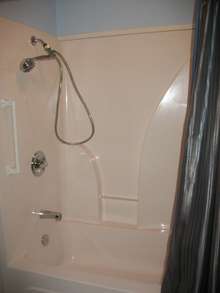 Primary Bathroom has tub/shower combo with handicap bar *  Shower curtain and all accessories may remain * 