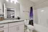 The bathroom with tile floors and granite counter.