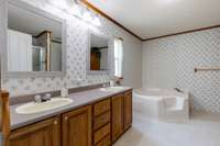 The primary bathroom has double vanities, a large bath tub and ample wooden cabinets! 391 Hilltop Lane Woodbury, TN 37190