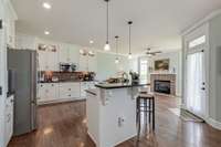 Sizable Sunny Kitchen w/ SS Appl/Double Oven/Gas Cooktop & Breakfast Nook w/ fireplace & floor to ceiling windows