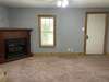 Living room with new carpet and gas fireplace