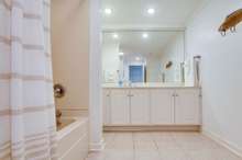 The guest Bath is huge with tub/shower combination, lots of cabinets, tile floors and storage. 