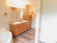 Primary Bath w/Double Vanity,extra Storage Cabinet, Spacious retreat with separate Tub and Shower