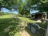 A portion of the back porch is fenced Storage building with covered area.