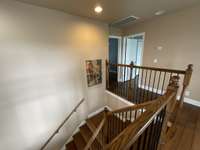 This side of the stairway leads to the other two bedrooms and bonus room.