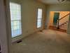 Opposite view of the living/family room. Front door is to the left of the stair case.