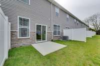 Back of home with patio space and partial fence  *Photo of decorated model