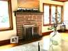 Gas log brick fireplace with mantle & mirror. . 