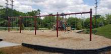 Playground with picnic tables, benches, & charcoal grills.