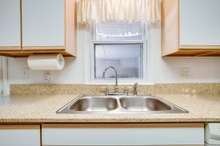 This kitchen features granite counter tops, Stove, DW, microwave, refrigerator and  2 sets of washers and dryers for all those towels from being out on the lake. 