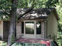 3 BR, 2 BA, on wooded sloped lot.