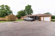 Large open parking in addition to your 1 car garage. *this storage shed will not convey with the property*