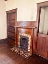 Living room fireplace with original tile, mantel, and built ins