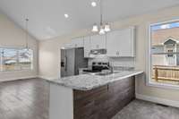 The kitchen also has granite countertops and classic white subway tile backsplash