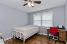 Bedroom one with double windows overlooking the backyard