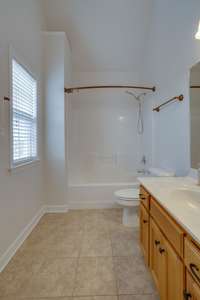 Primary bathroom with tile flooring.