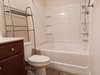 Now time to relax!  Large garden tub/shower combo, with large vanity. Shelving remains.