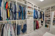 Custom closet is professionally outfitted to optimize the space and lend an elegant look