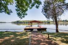 This home has its own dock with electricity, lights around the dock, swimming platform, and just look at that view. Bring your boat and play on the lake. The dock is 24x18