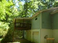 Rear view of home, covered back deck