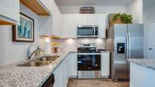 Granite Counters and SS Appliances.  Picture of model home.