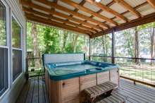 The hot tub is at one end of the covered porch! Sit and watch the lake even in the rain. 12’x47’ porch to watch the lake 