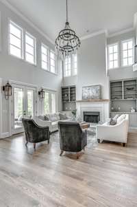 The cathedral ceiling allows for great natural light in this gorgeous room complete with a fireplace.