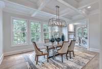 The dining room offers ample space as well as gorgeous natural light from the 4 windows.  Also, it features a coffered ceiling.