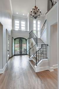 The newly laid white oak hardwoods are the perfect compliment to the gorgeous gray walls!  This 3 level home has a gorgeous staircase as well as an elevator that services all 3 levels.