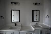Jack and Jill bathroom between two bedrooms downstairs! Double vanity! Tile floors!