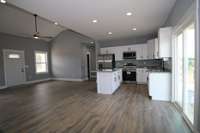 WOW - look at all those can light and did you notice those cabinets? When you actually walk through this house...don't forget to open and close them because they are the easy close type. No slamming drawers or doors in this kitchen.