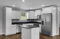 Custom Wood Cabinets & Island with Quartz Countertops. Stainless steel appliances with Brushed Nickel Finishes.