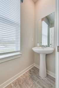 Powder room downstairs. *Photos of model home - colors and finishes will vary in actual home under construction