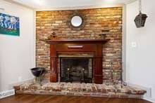 The fireplace, a lovely focal point, has been converted to gas logs.