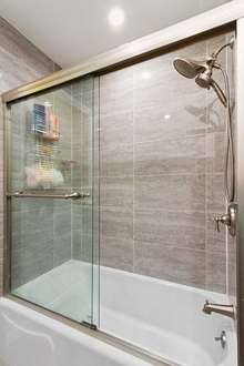 Tile surround shower and tub and with tile flooring.