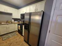 Lots of cabinets with Smooth Top Stove, built-in microwave and dishwasher.