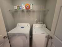 Separate utility room with wire shelving.