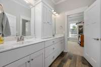 double sink with one shower and toilet joining the adjacent guest rooms