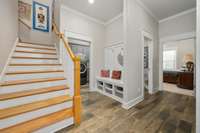 garage entrance view, stairs, laundry room, half bath, and master bed