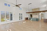 View of the Great Room from the opposite side of the Living area. Barnwood beams and mantle