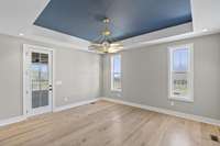 Master Suite on the Main Level w/exit door leading to the back covered Porch and pool/cabana area. 10’ Tray Ceiling. Leads to Master closet that has a hidden door off of the pantry.