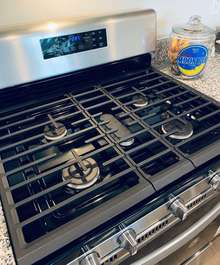 The actual home for sale has stainless appliances including a 5 burner gas stove.