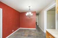 The dining room opens onto the first of TWO eat-in kitchens in the home